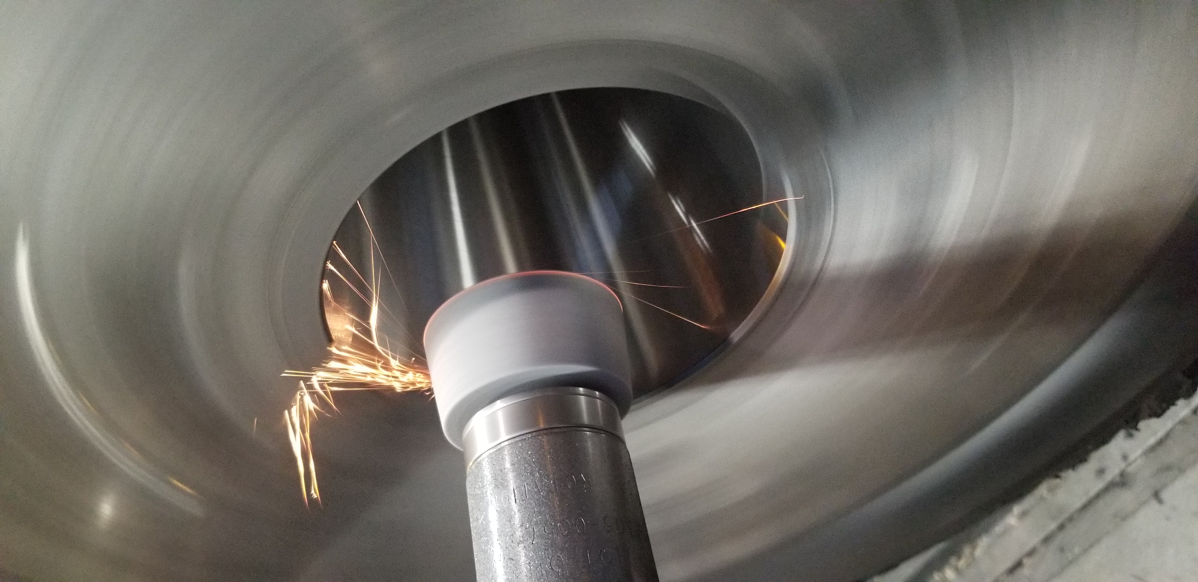 In-place grinding setup working on the inside taper of a machine-tool spindle.