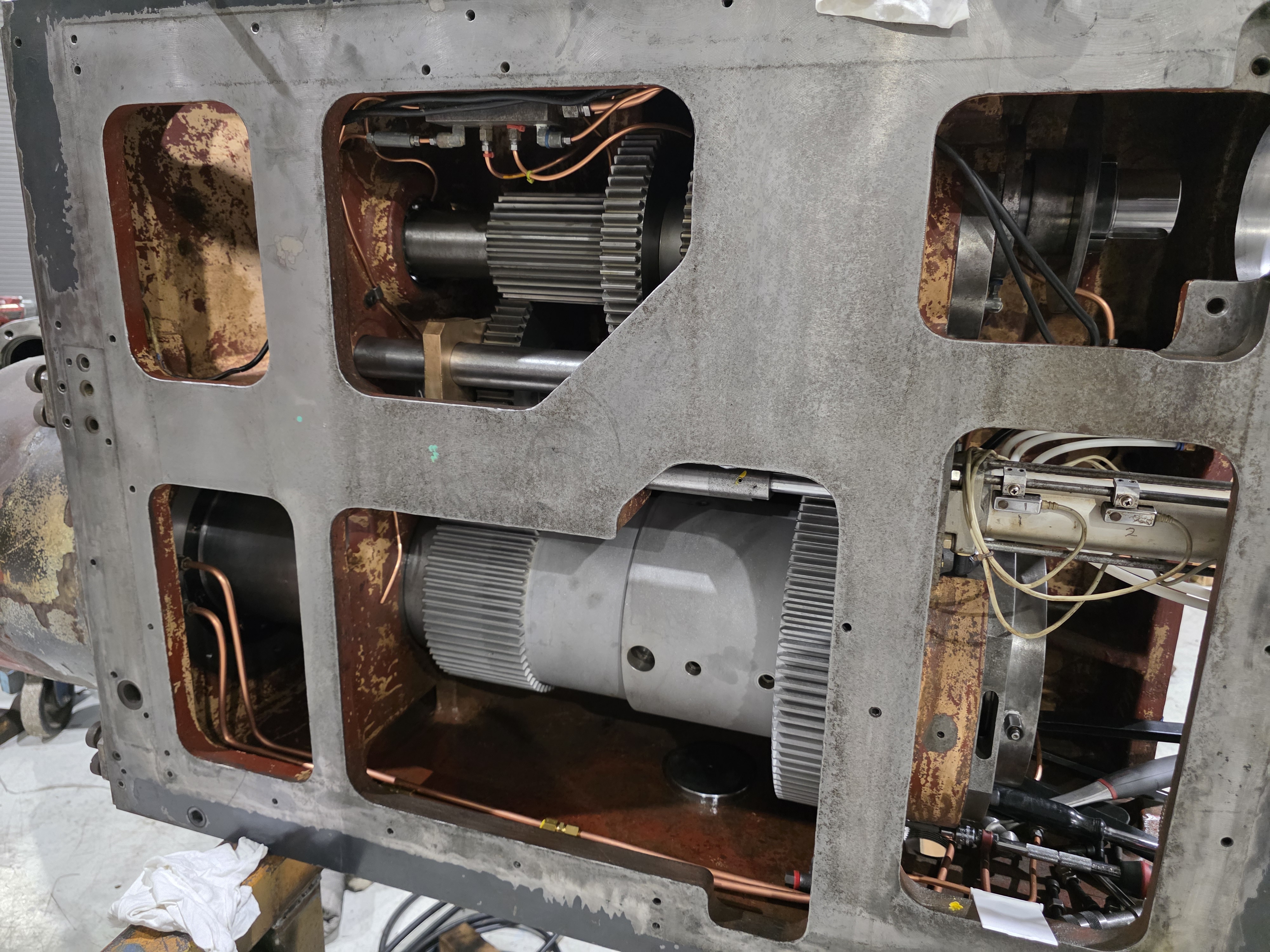 Machine headstock opened during a spindle rebuild, with internal drive components exposed.