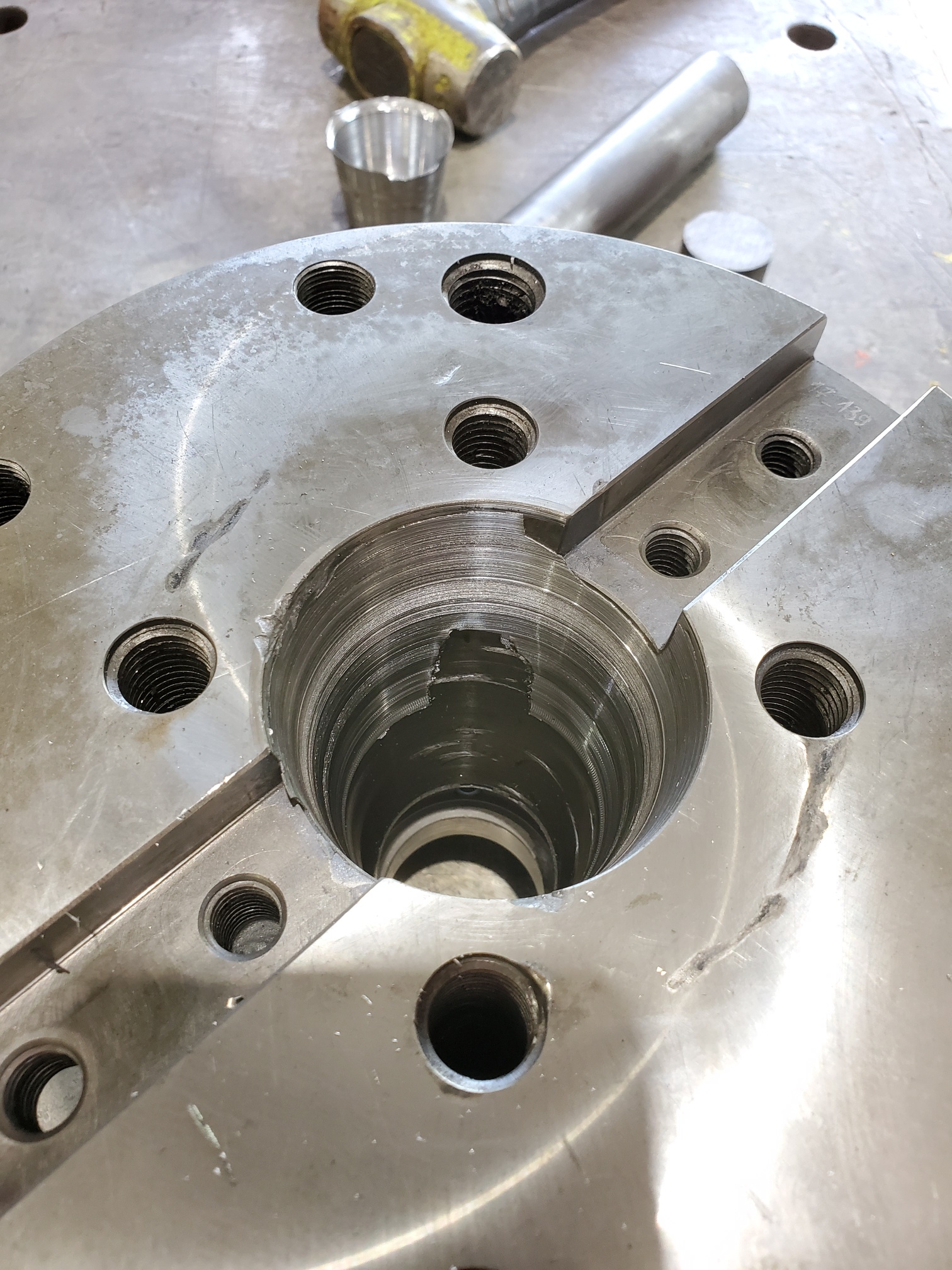 Toolholding spindle taper before corrective grinding, showing the worn contact surface.